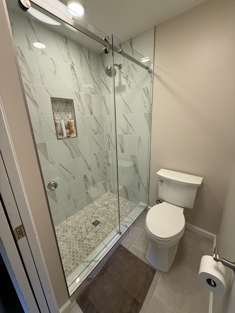 Sliding glass shower enclosure and tiled niche