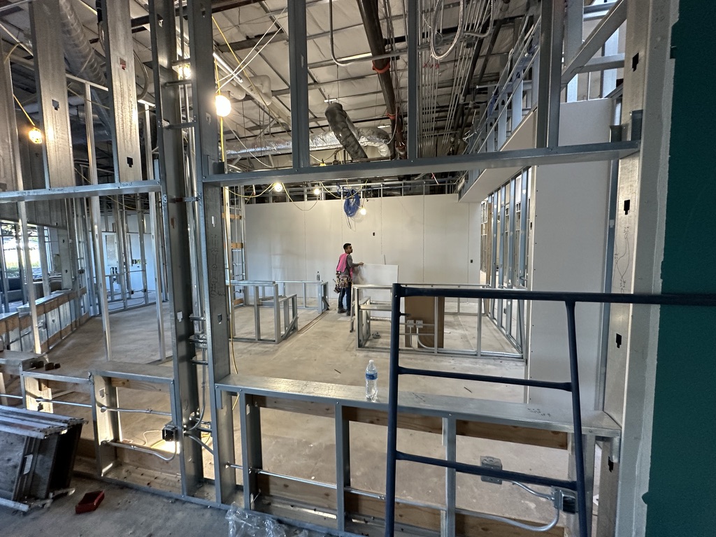 During construction — interior metal framing and overhead utilities